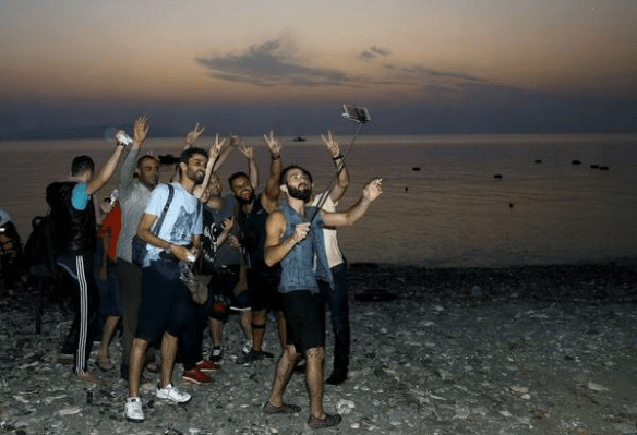 migrants with selfies